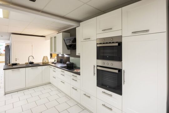 Witte landelijke keuken met hoge kasten